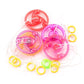 Three translucent plastic ring toys in red, pink, and purple, shown with small yellow and green rings on a white background.