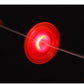 A glowing red and orange spinning disc toy, likely a light-up yo-yo or LED spinner, captured in motion against a solid black background with fingers visible on the left and right edges holding the string.