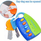 A colorful smart remote keychain toy with a blue and green body, orange and blue buttons, attached keys, and a circular inset showing the key ring opening mechanism. Blue text at the top reads 'Key ring can be opened'.