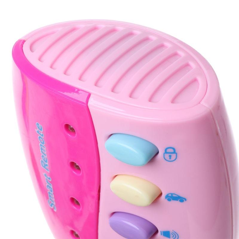 Pink toy remote control with colorful buttons on a white background