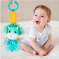 Happy Baby Playing with a Musical Dinosaur Rattle Toy
