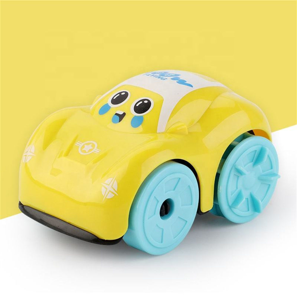 Yellow toy car with blue wheels on a white surface against a yellow background