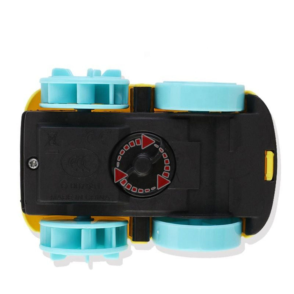 A top-down view of a small toy vehicle chassis, likely a magnetic toy car or train, featuring a black plastic base, yellow side panels, and four light blue wheels.